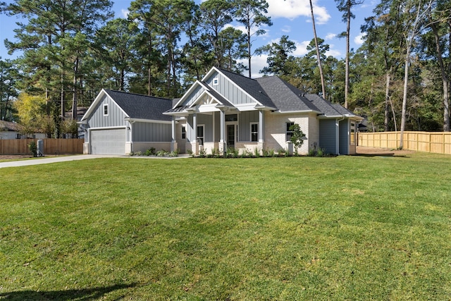 view of front of house with a porch, a garage, and a front lawn