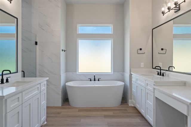 bathroom featuring vanity, a healthy amount of sunlight, and hardwood / wood-style flooring