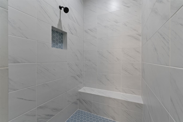 bathroom with tiled shower