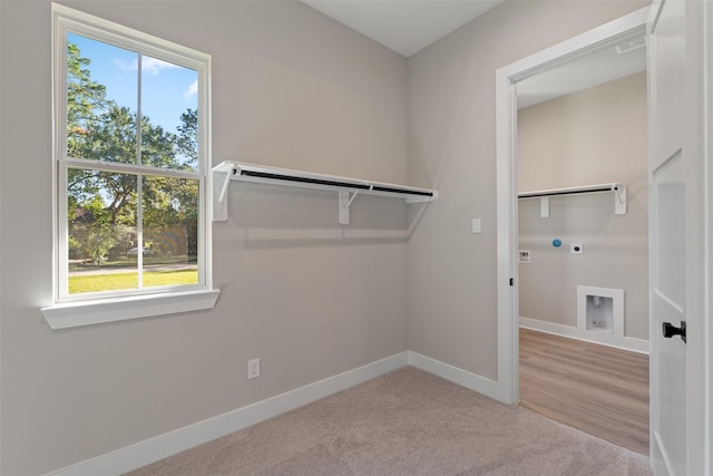 laundry room featuring a wealth of natural light, laundry area, hookup for an electric dryer, and baseboards