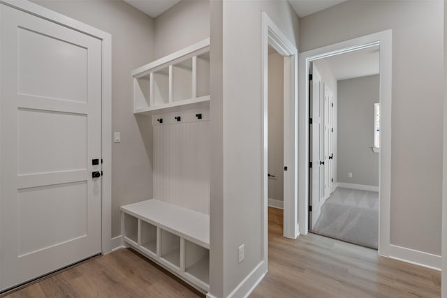 mudroom featuring light wood-type flooring and baseboards