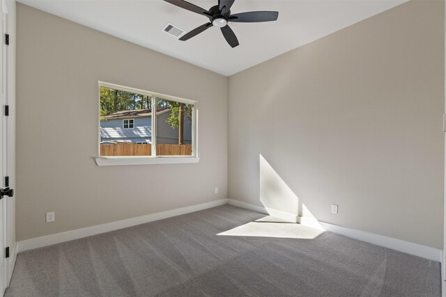 carpeted spare room featuring ceiling fan