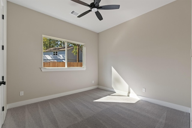 carpeted empty room featuring a ceiling fan, visible vents, and baseboards