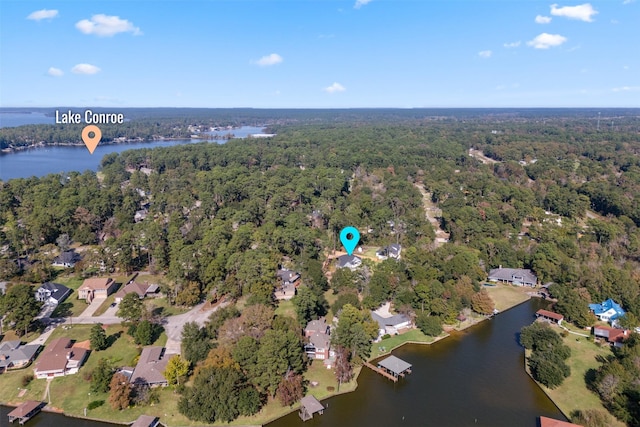 drone / aerial view featuring a water view and a wooded view