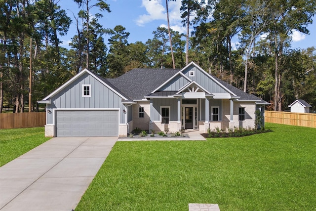 view of front of house with a garage, a front yard, and a porch