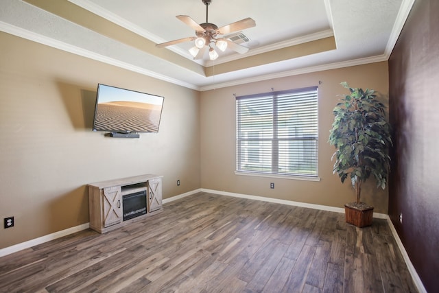 unfurnished living room with hardwood / wood-style floors, ceiling fan, a raised ceiling, and ornamental molding