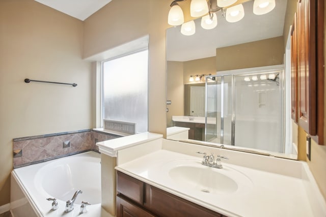 bathroom featuring vanity and independent shower and bath