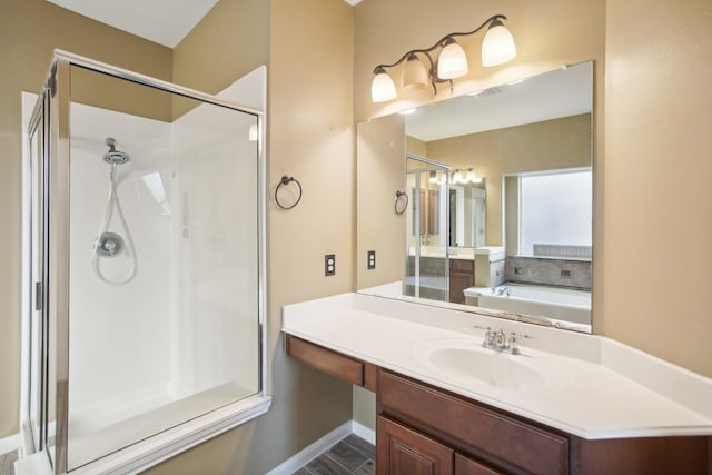 bathroom with vanity and independent shower and bath