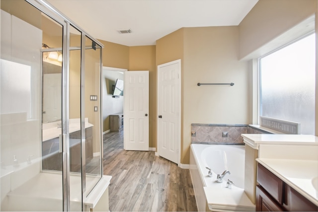 bathroom featuring separate shower and tub, vanity, and hardwood / wood-style flooring