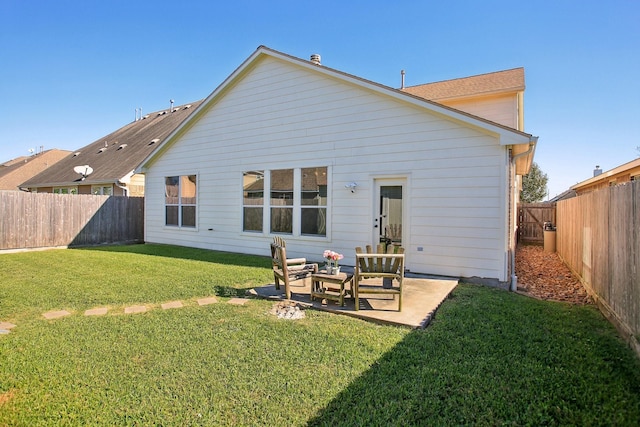 back of house with a lawn and a patio area