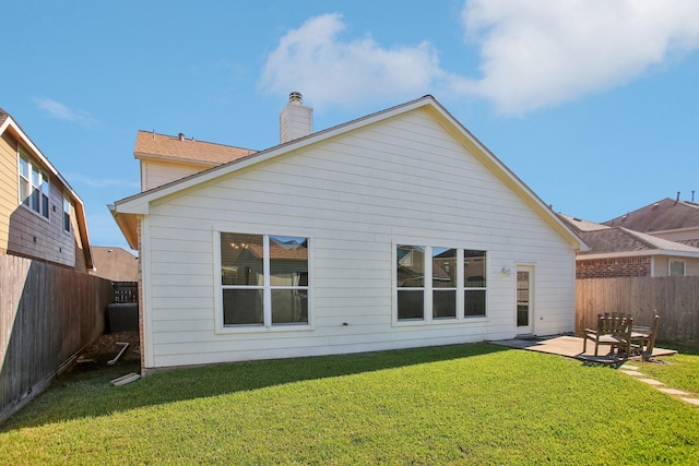 back of property featuring a patio and a lawn