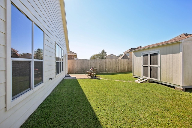 view of yard featuring a patio area and a storage shed