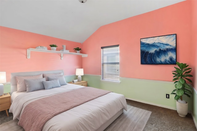 carpeted bedroom featuring lofted ceiling