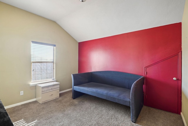 sitting room featuring carpet and vaulted ceiling