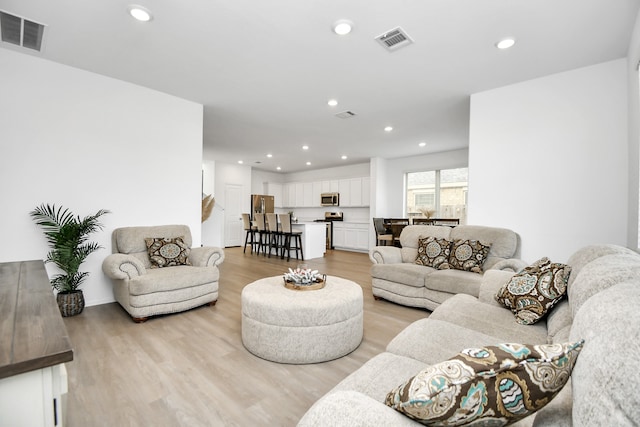 living room with light hardwood / wood-style flooring