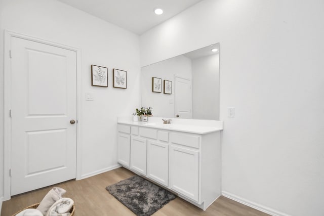 bathroom with hardwood / wood-style floors and vanity