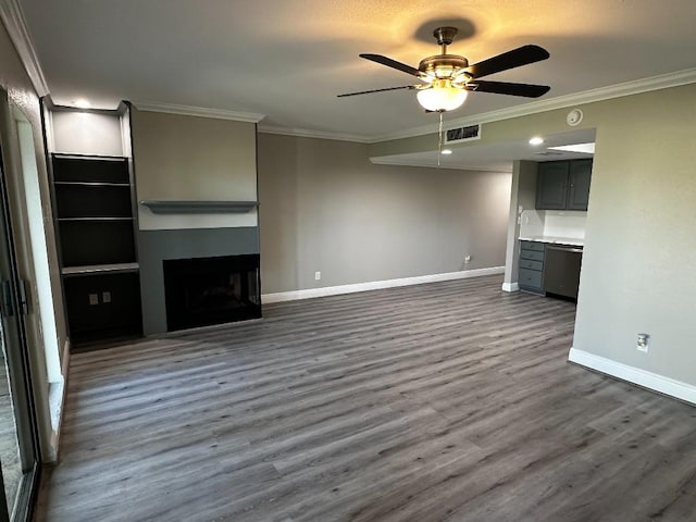 unfurnished living room featuring ceiling fan, dark hardwood / wood-style flooring, and ornamental molding