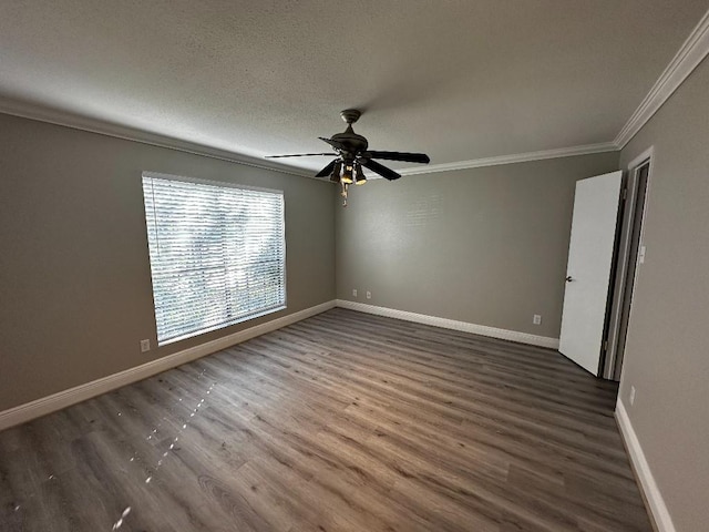 empty room featuring a textured ceiling, dark hardwood / wood-style floors, ceiling fan, and crown molding