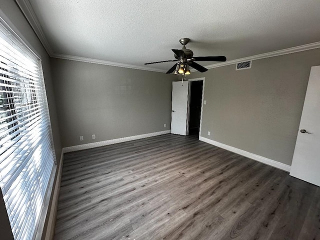 empty room with ceiling fan, crown molding, and dark wood-type flooring