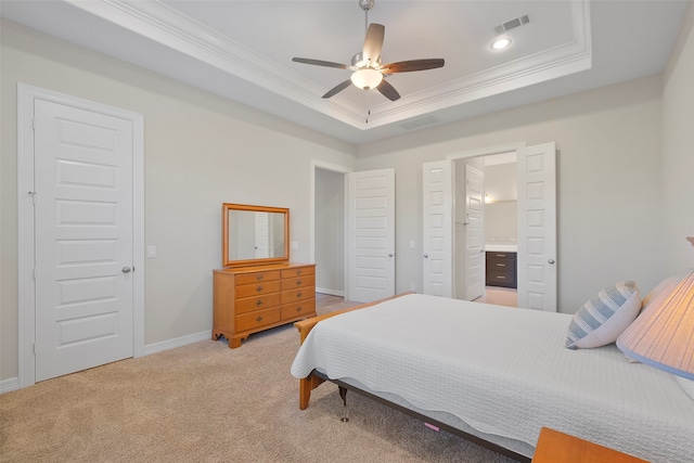 bedroom featuring ensuite bath, ceiling fan, a raised ceiling, light carpet, and ornamental molding