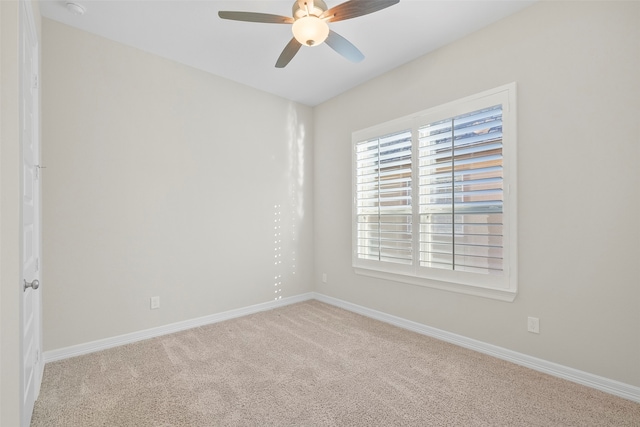 unfurnished room with ceiling fan and light colored carpet