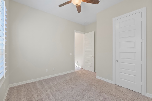 unfurnished bedroom with ceiling fan and light carpet