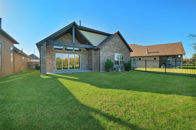 back of house with a yard and a patio