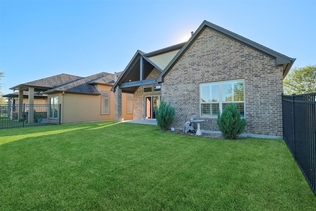 rear view of house with a lawn