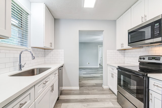 kitchen featuring white cabinets and appliances with stainless steel finishes