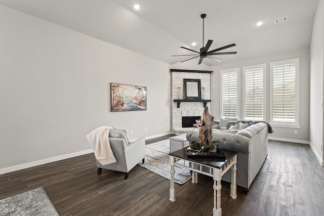 living room with a fireplace, dark hardwood / wood-style floors, ceiling fan, and lofted ceiling