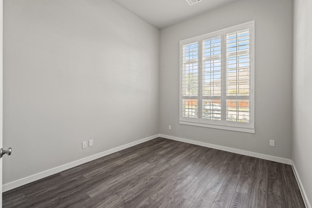 unfurnished room with dark wood-type flooring