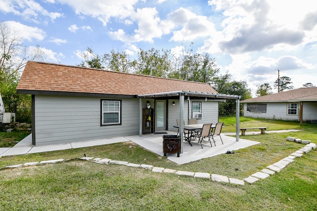 rear view of property with a patio area, a yard, and cooling unit