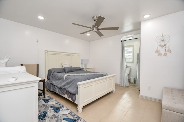 tiled bedroom with ceiling fan and ensuite bath