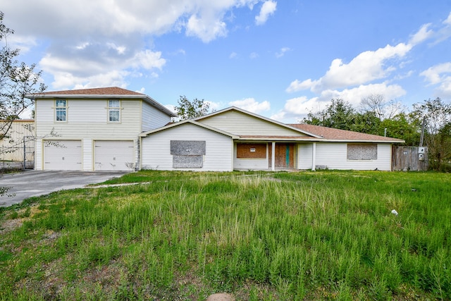 view of front of property with a front lawn and a garage