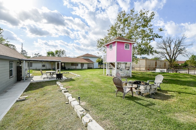 view of yard featuring a fire pit and a patio area