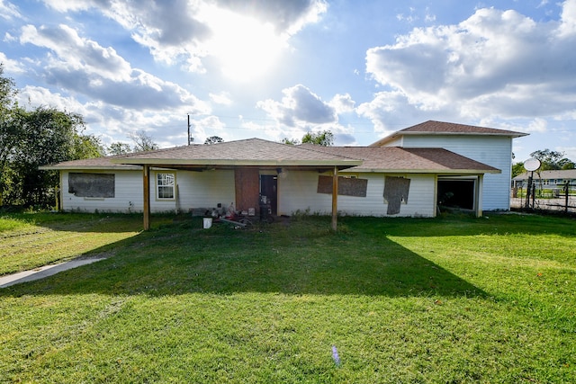 rear view of property featuring a lawn