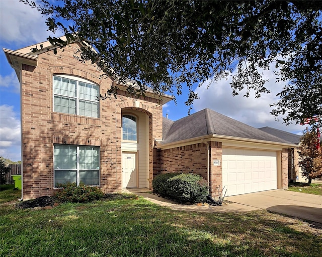 view of front facade with a front yard and a garage