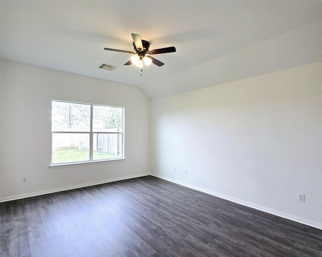 empty room featuring vaulted ceiling, ceiling fan, and dark hardwood / wood-style floors