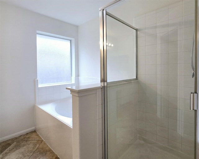 bathroom featuring tile patterned floors and separate shower and tub