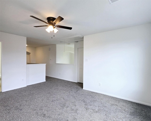 carpeted spare room featuring ceiling fan