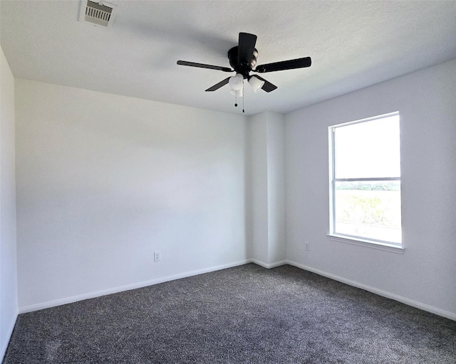 carpeted spare room with a textured ceiling and ceiling fan