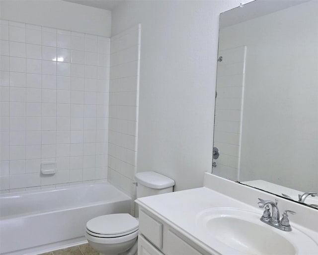 full bathroom with tile patterned flooring, vanity, tiled shower / bath combo, and toilet