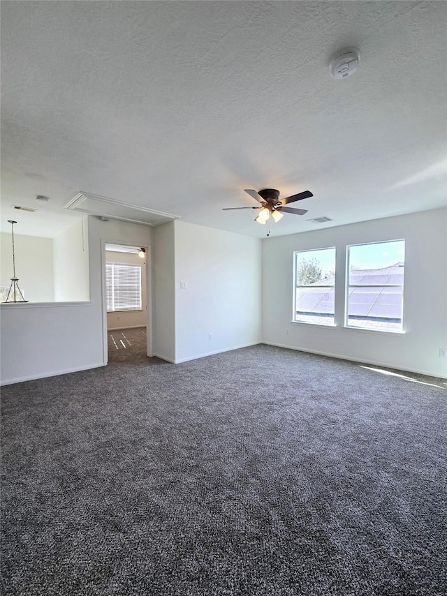 carpeted spare room with ceiling fan and a textured ceiling