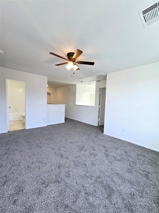 empty room featuring dark carpet and ceiling fan