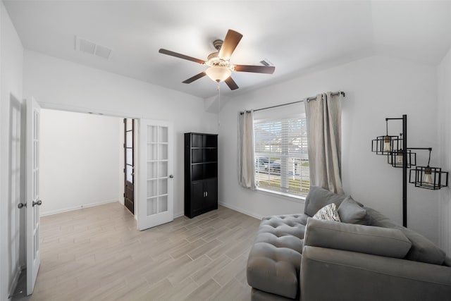 sitting room featuring lofted ceiling, ceiling fan, light wood-type flooring, and french doors