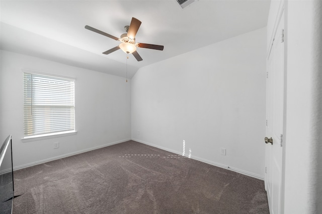 carpeted spare room featuring ceiling fan