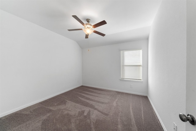 carpeted empty room with ceiling fan and vaulted ceiling