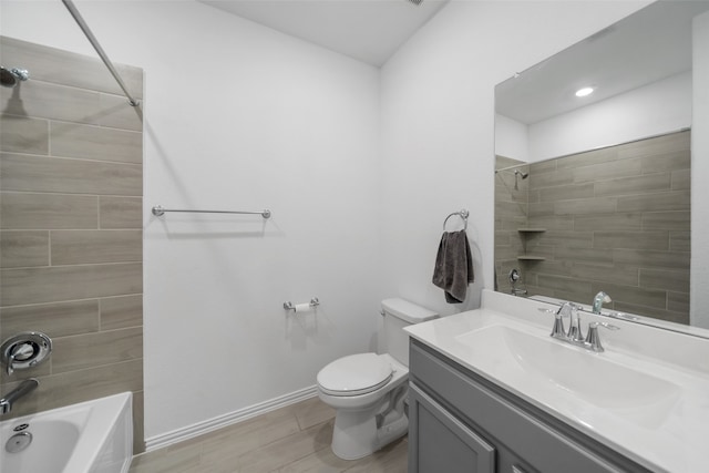 full bathroom featuring hardwood / wood-style floors, vanity, toilet, and tiled shower / bath