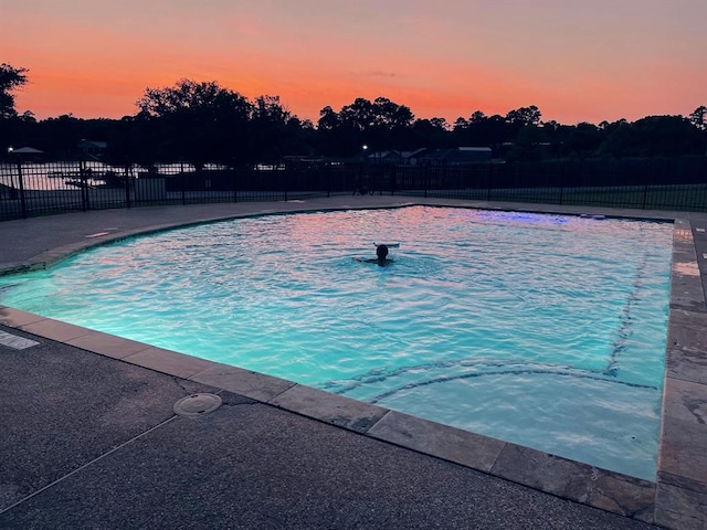 view of pool at dusk