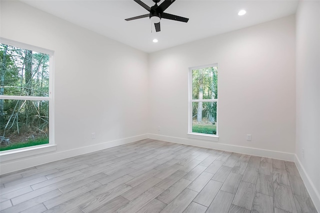 empty room featuring ceiling fan and light hardwood / wood-style floors